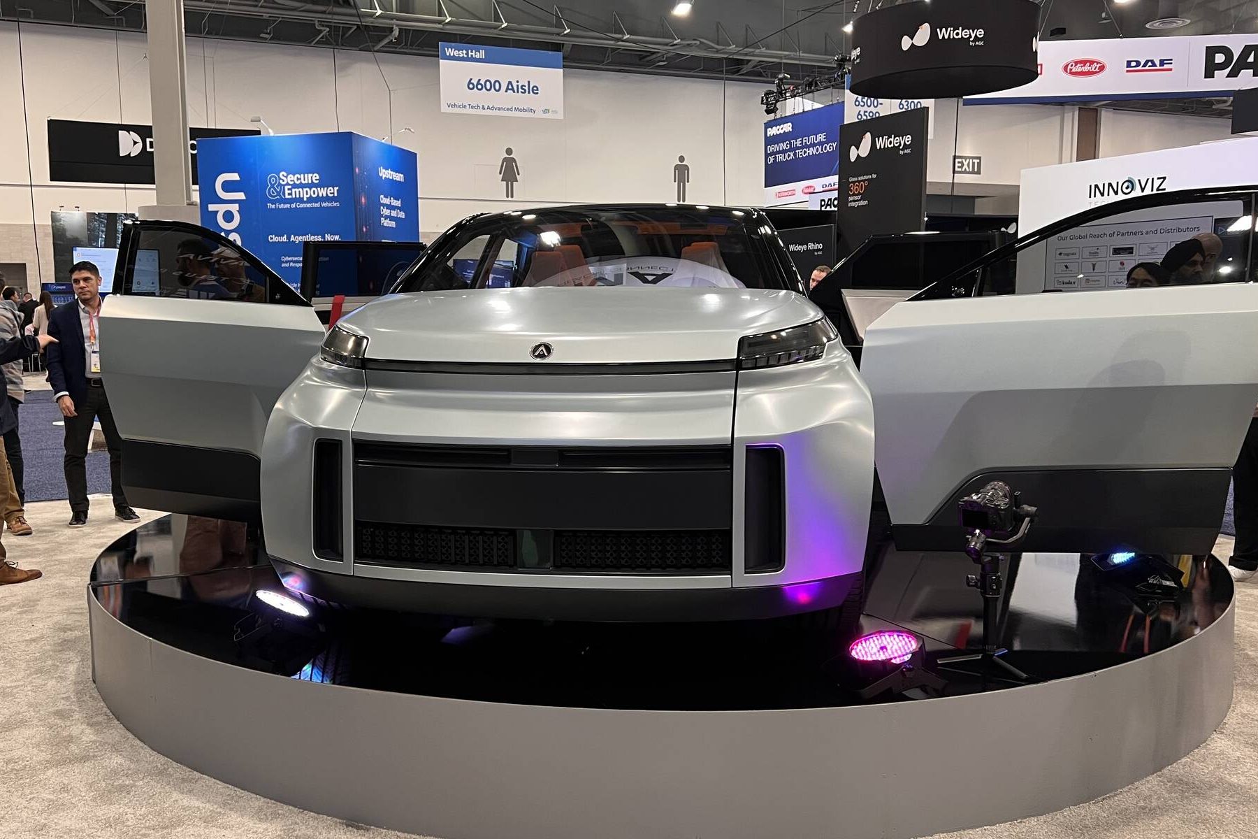 Project Arrow EV showcased with doors open at an industry expo